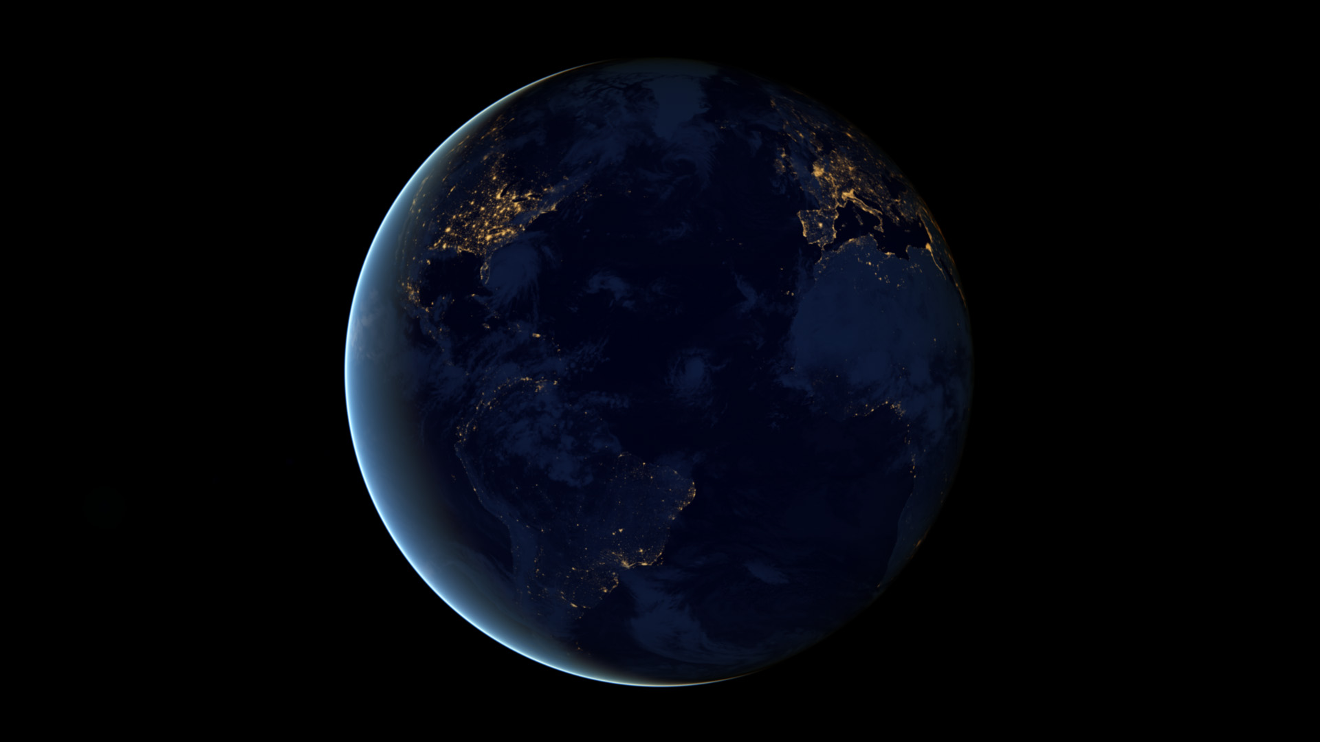 The Americas, Europe and Africa at night, seen from space, with city lights along the coasts